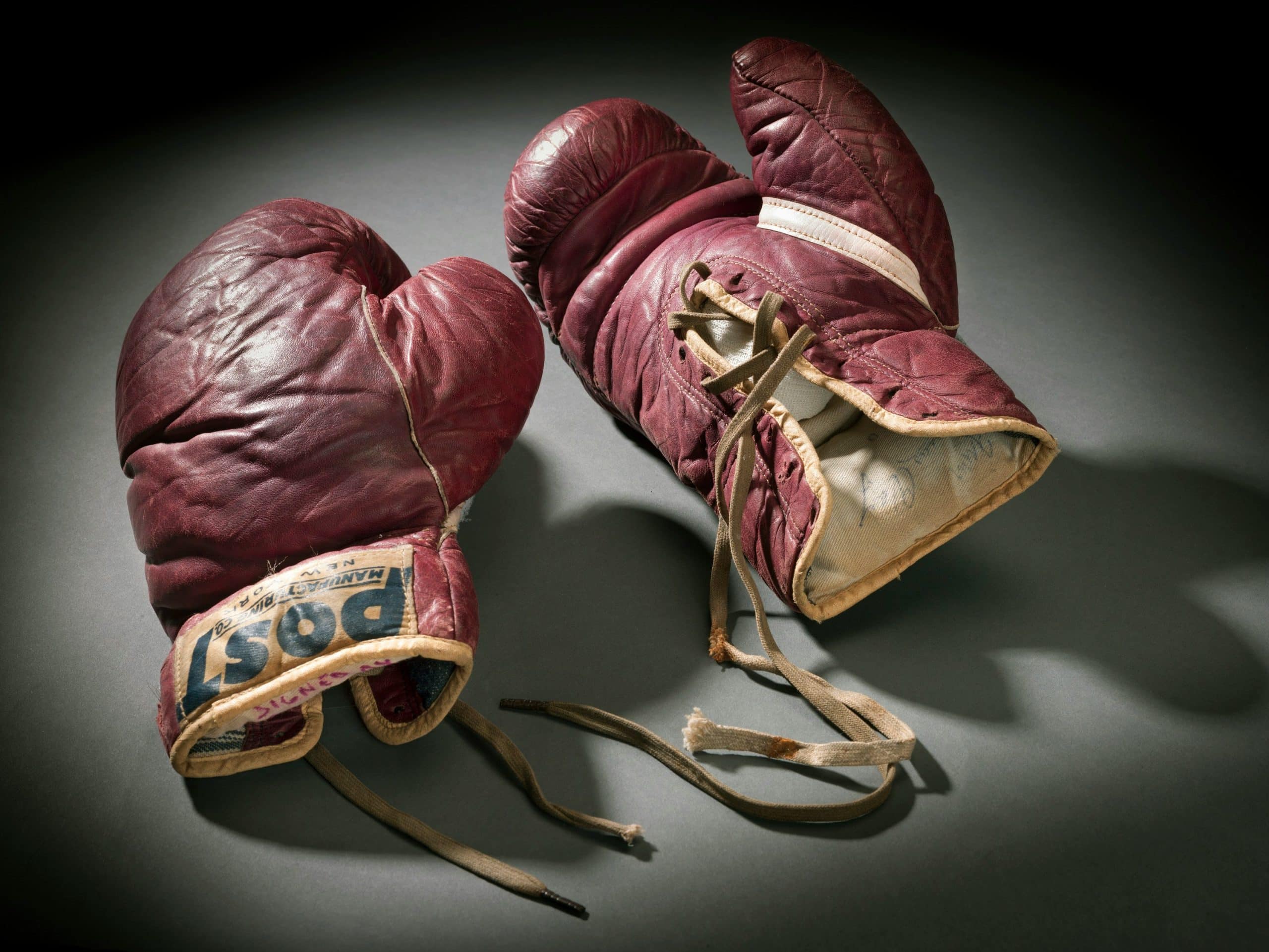 Dark red brown training boxing gloves worn by Cassius Clay (Muhammad Ali). Image Credit: Smithsonian / Unsplash